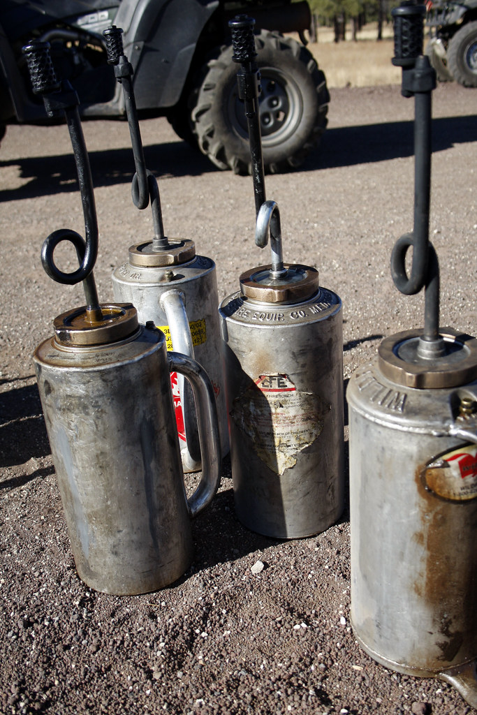 Drip torches Drip torches sit filled with a part gasoline,… Flickr