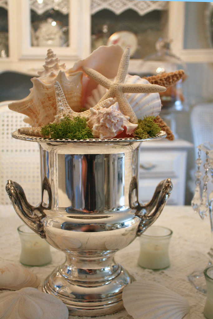 Centerpiece The champagne bucket and the large shell were … Flickr