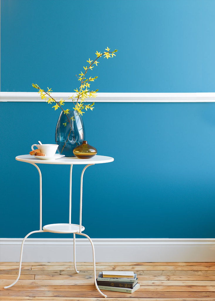 Yellow flowers against bright blue wall We're very happy f… Flickr