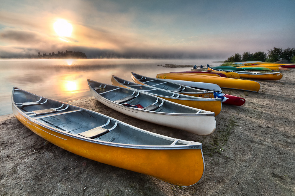 Canoes at sunrise Canoes sit on the shore on a beach at Al… Flickr