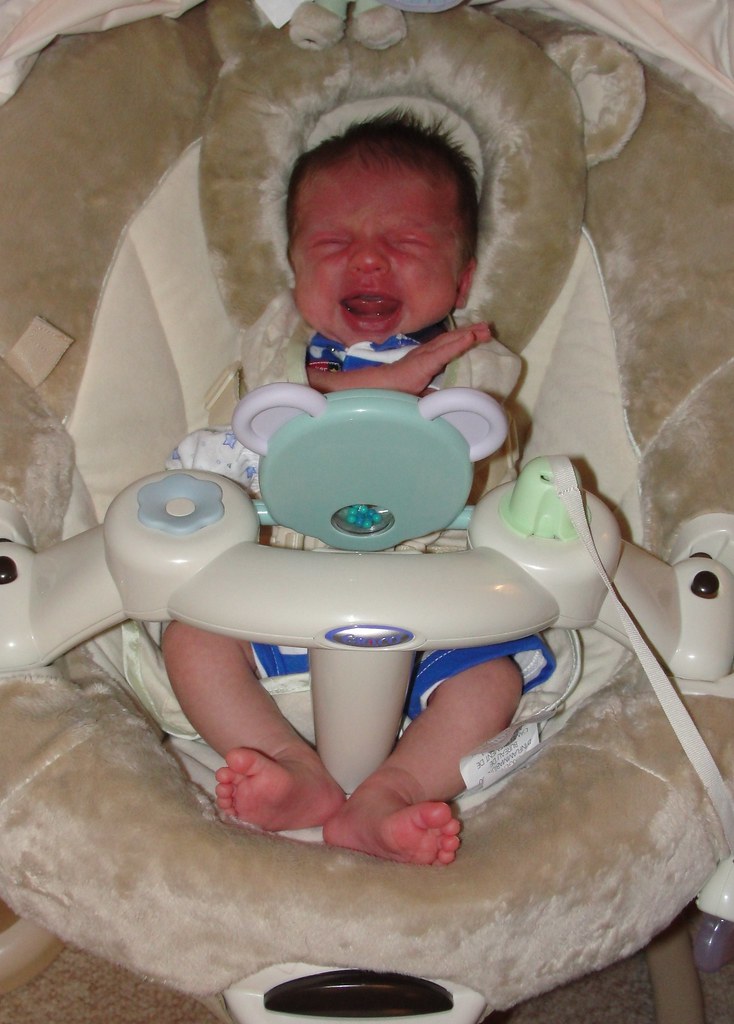 Tomato face Killian busting out of his swaddle blanket and… Flickr