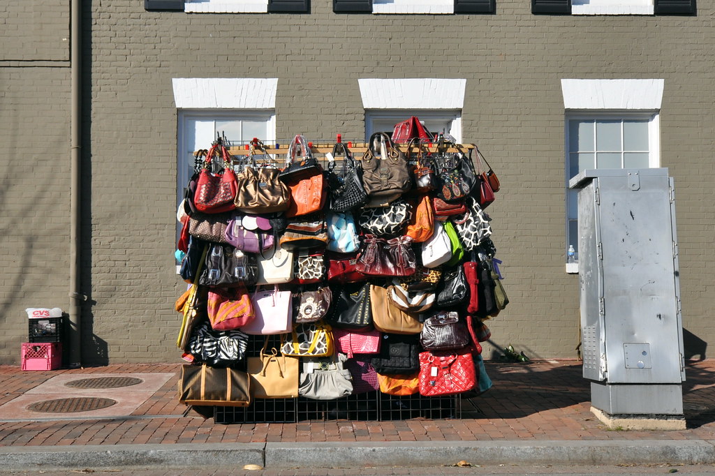 Cheap Purses A stand of presumably cheap knockoff purses,… Flickr