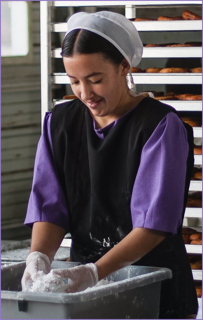 Amish girl making thousands of doughnuts. The annual
