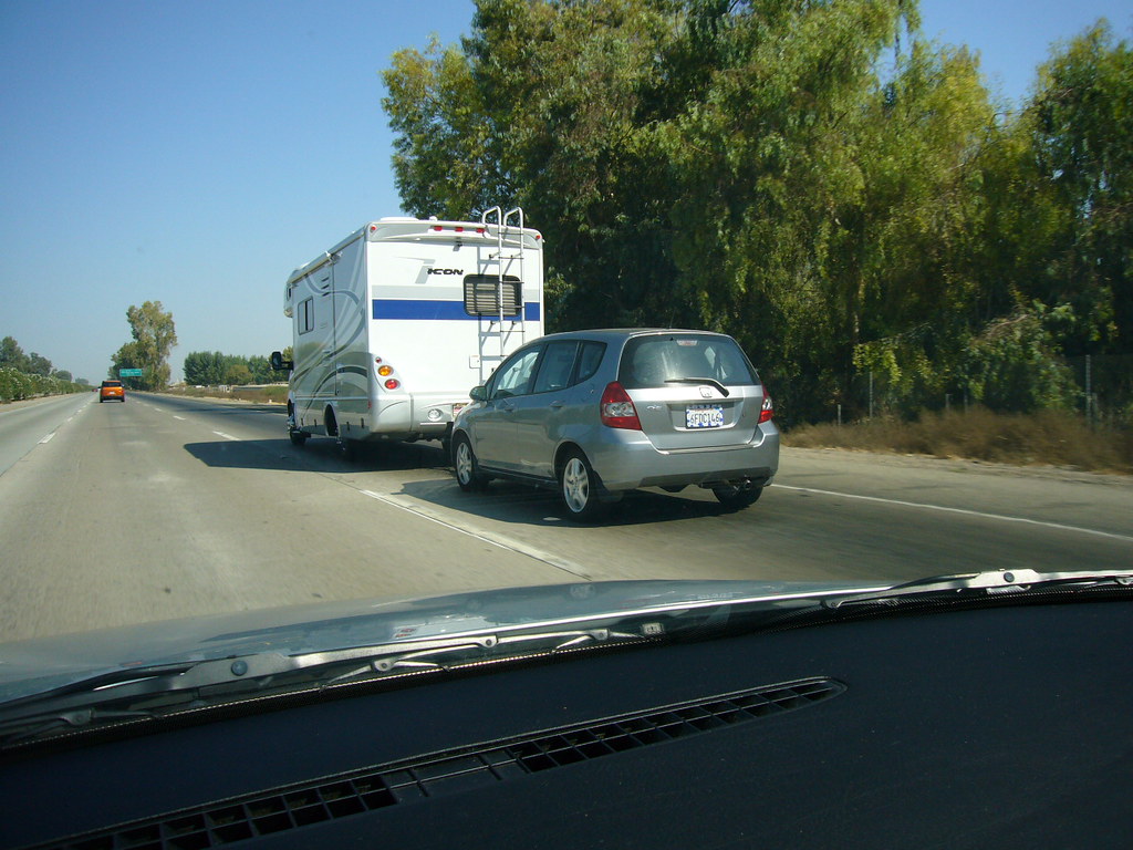 RV towing a Honda Fit how ironic is this? jefurii Flickr