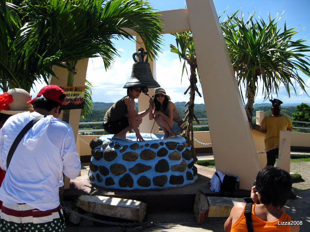 Ring my bell Korean tourists under the wishing well/bell. … Flickr