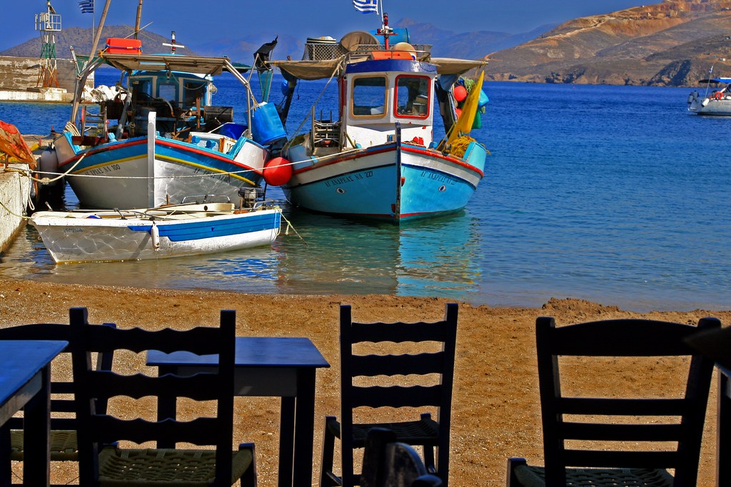 Chairs and boats, Leros island A few wooden chairs in a ta… Flickr