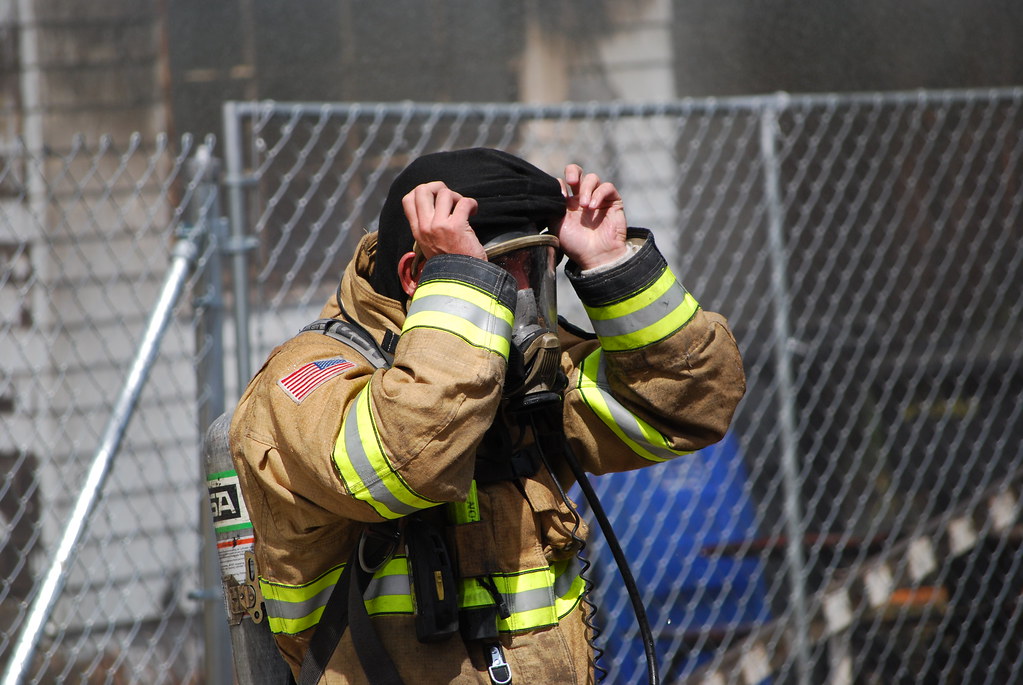 Fireman putting on head gear, close up House fire in Magna… Flickr