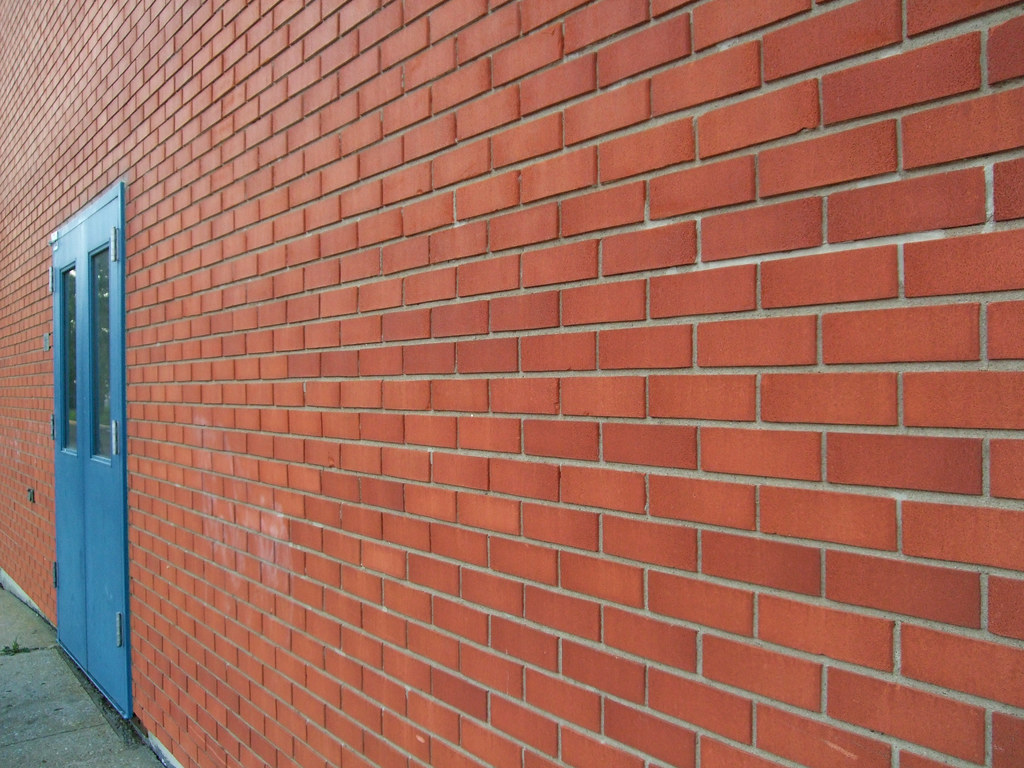 Blue Door & Brick Wall Optical Illusion the left side of… Flickr