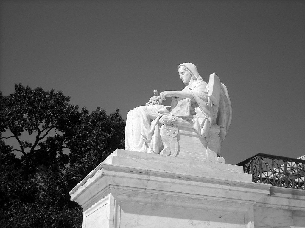 justice One of the statues outside the Supreme Court build… Flickr