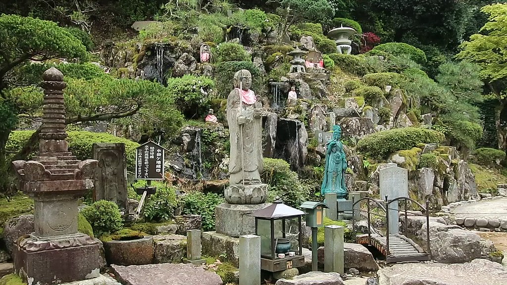 Jizo figures in bibs and Bodhisattva in green at memorial … Flickr