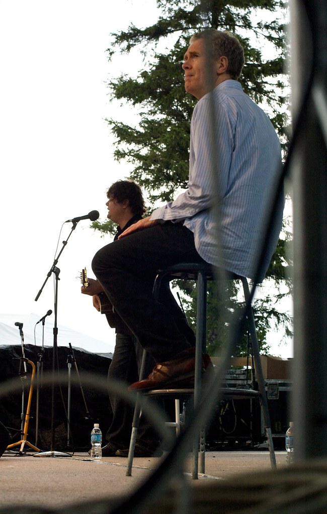 dark skies on the horizon, dark lines under his eyes a photo on