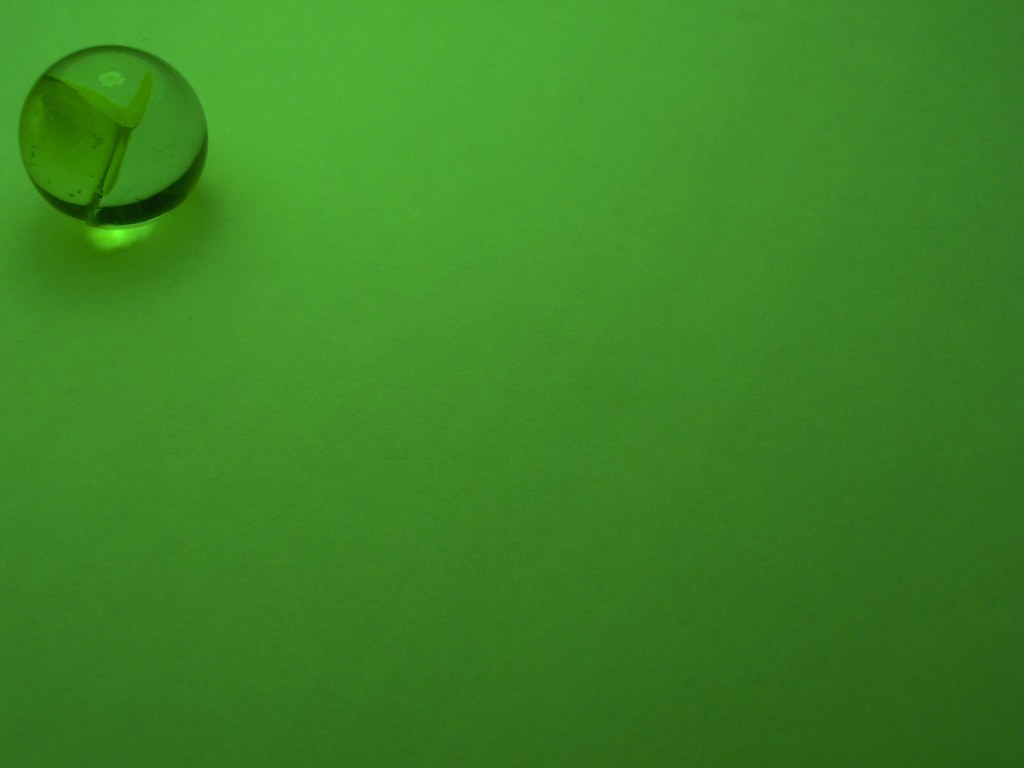 yellow marble yellow marble over a white piece of paper e… Flickr