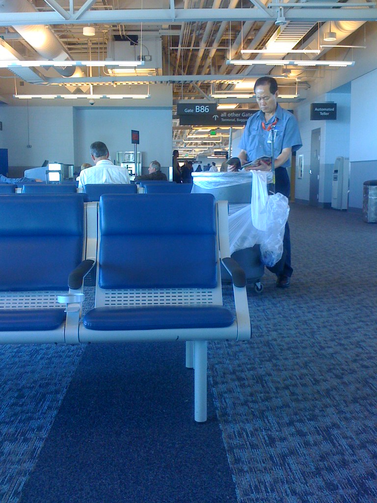 Janitor, reading US weekly At Denver airport. He stopped, … Flickr