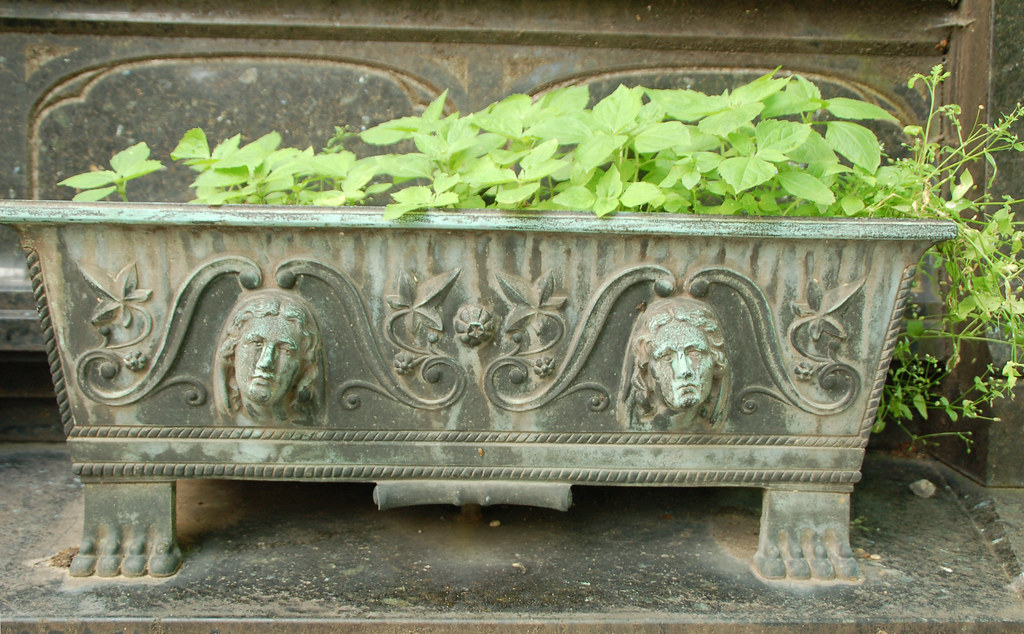 Metal cemetery planter with women's faces © All Rights Res… Flickr