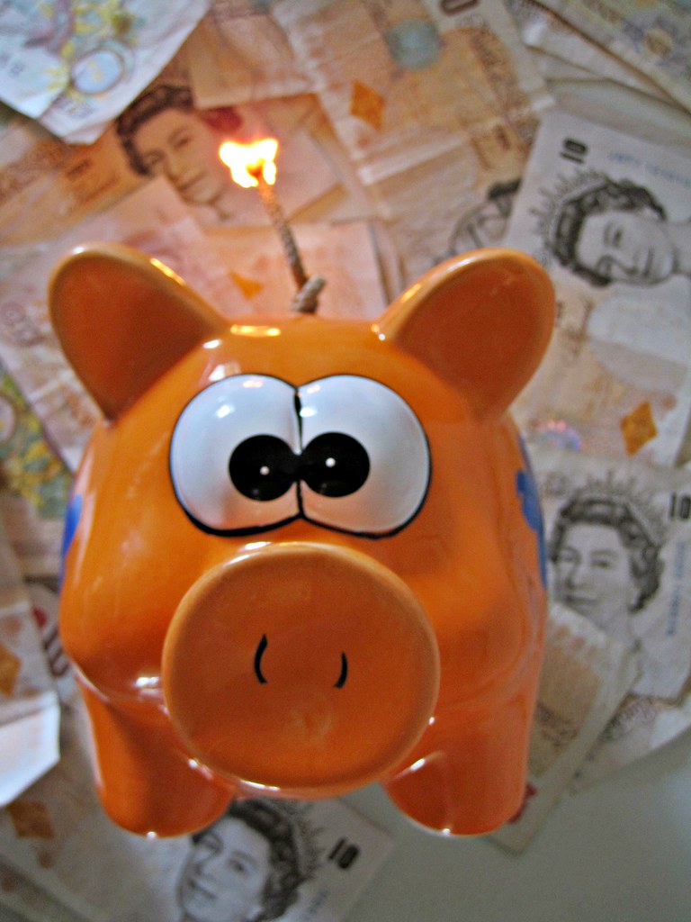 Piggy Bank with lighted fuse A piggy bank which is about t… Flickr