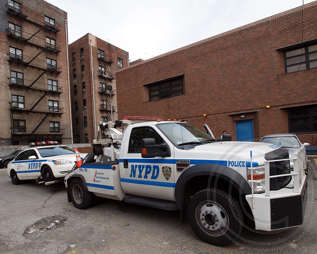 P034s NYPD Tow Truck towing a Police Patrol Car, Washington Heights, New York City a photo on