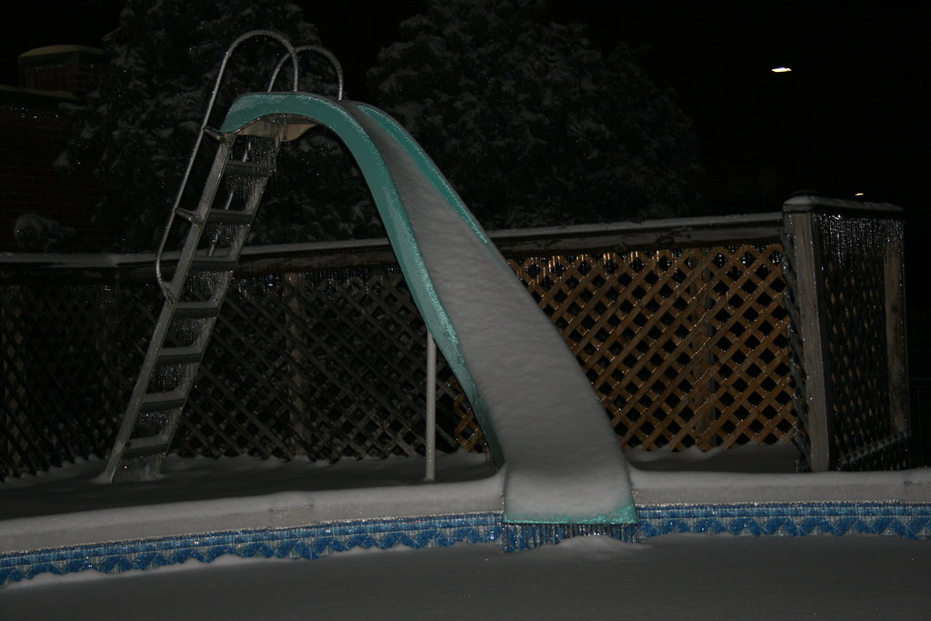 Sliding board The sliding board into my pool covered in sn… Flickr