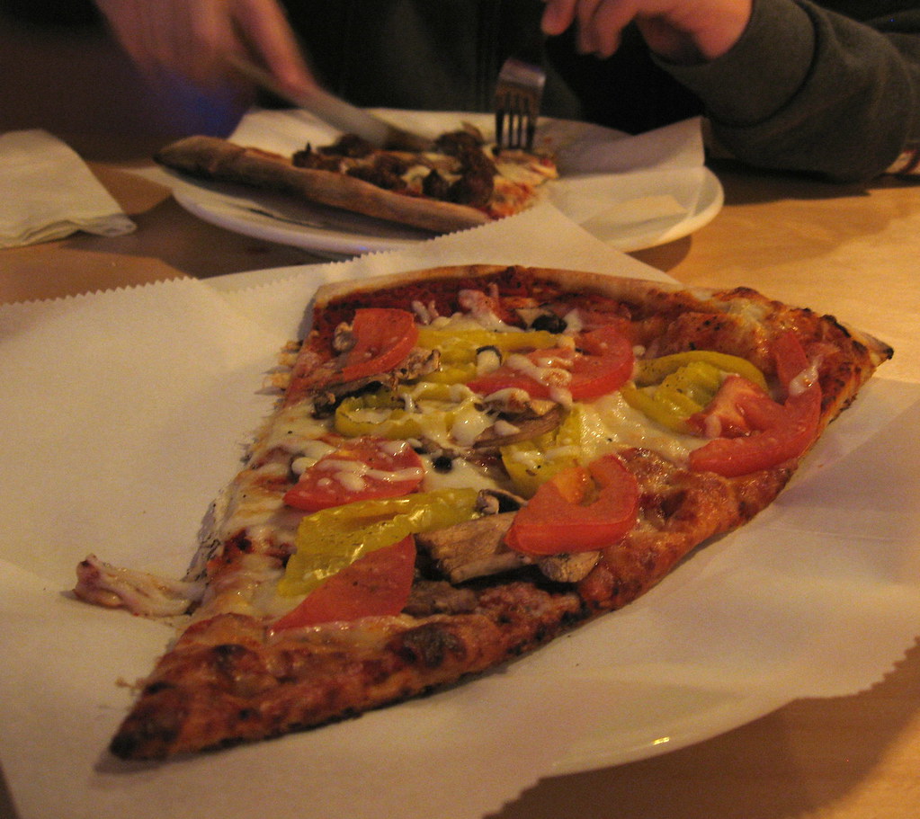 Roman Candle Pizza by the slice. Mine has Roma tomatoes, f… Flickr