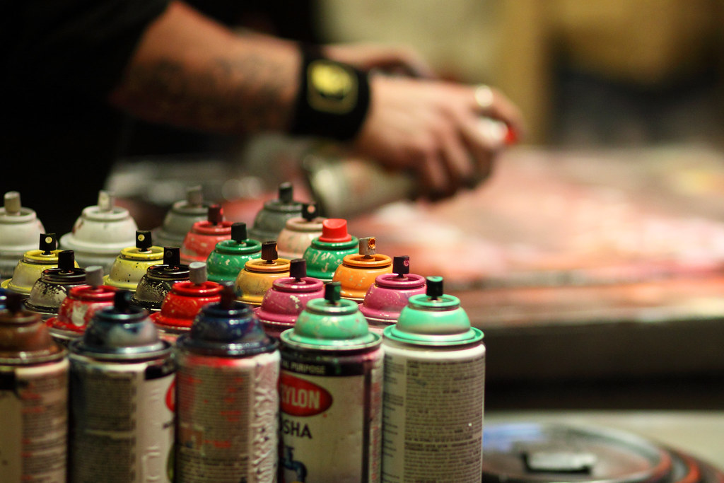 Paint Cans A spray paint artist demonstrating for a crowd … Flickr