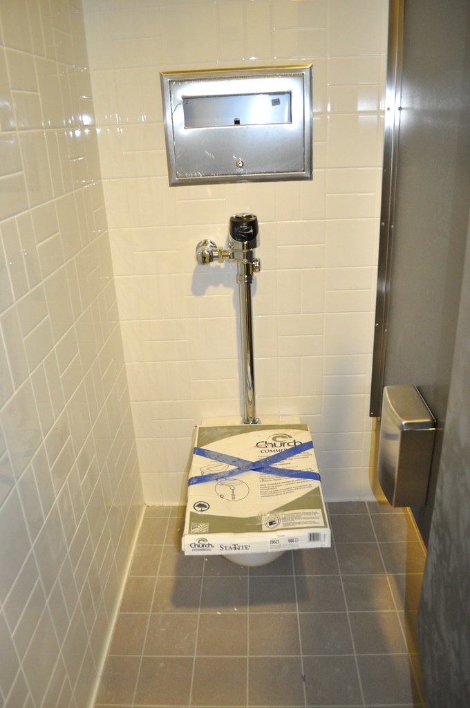 A men's bathroom stall on the first floor; space between t… Flickr