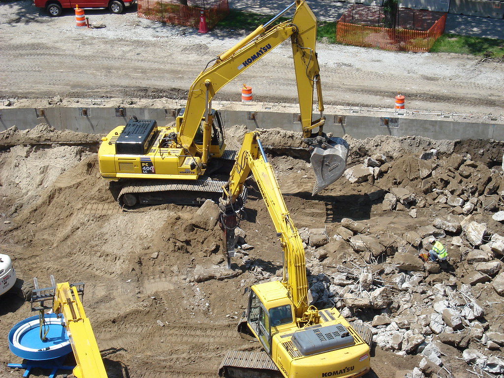 Backhoe and hydraulic jackhammer at work (Photo of Mansuet… Flickr