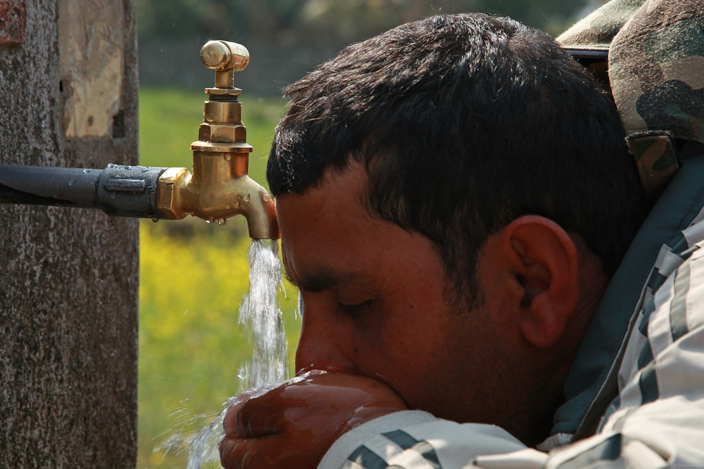 Man drinks water from tap in Kaski, Nepal Water tap in Kas… Flickr