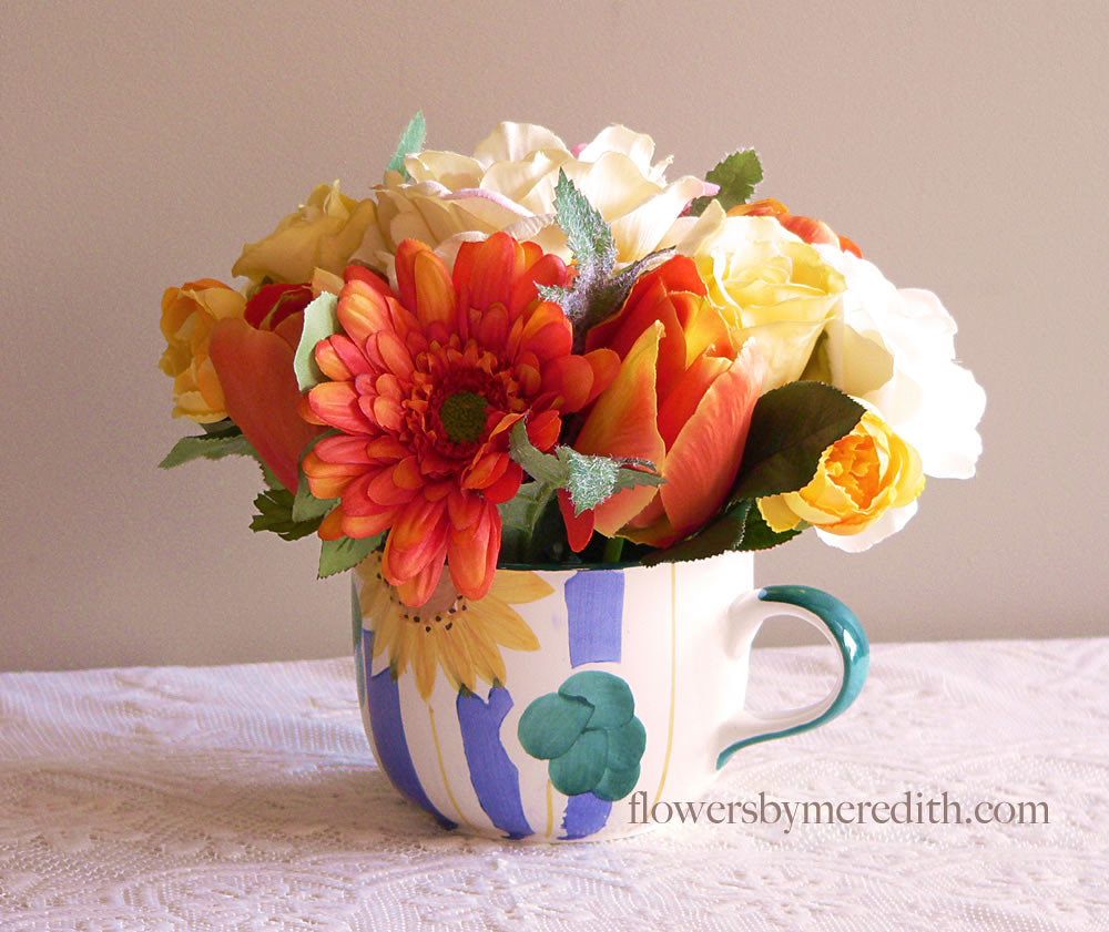 silk flower arrangement Silk flowers arranged in a large c… Flickr