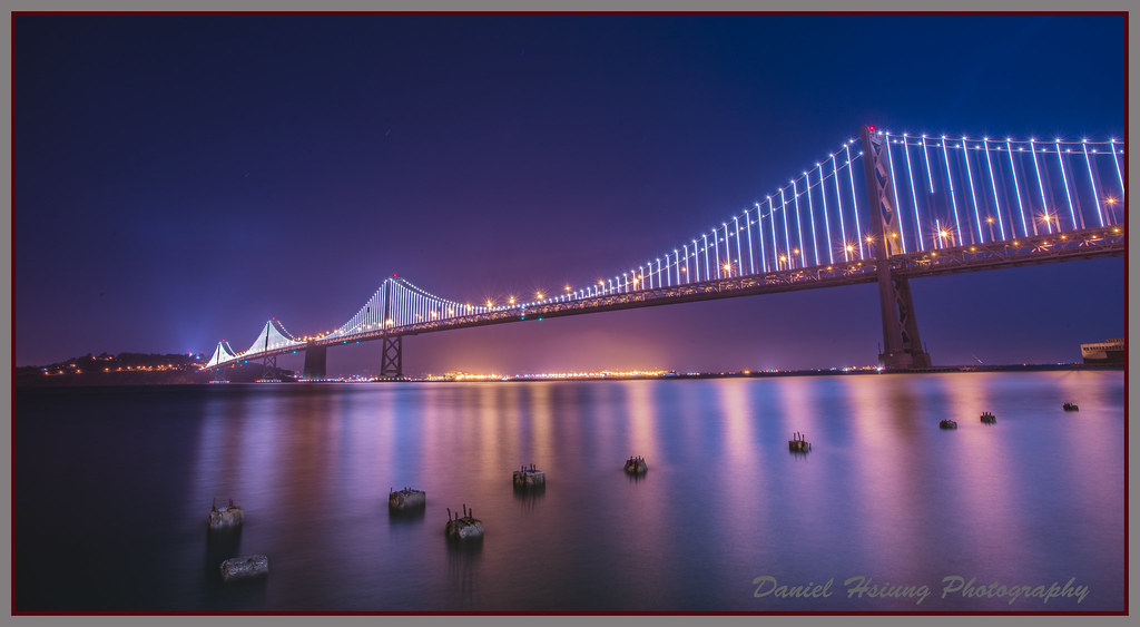 SF bay bridge night shot with bay bridge LED lights on. Daniel