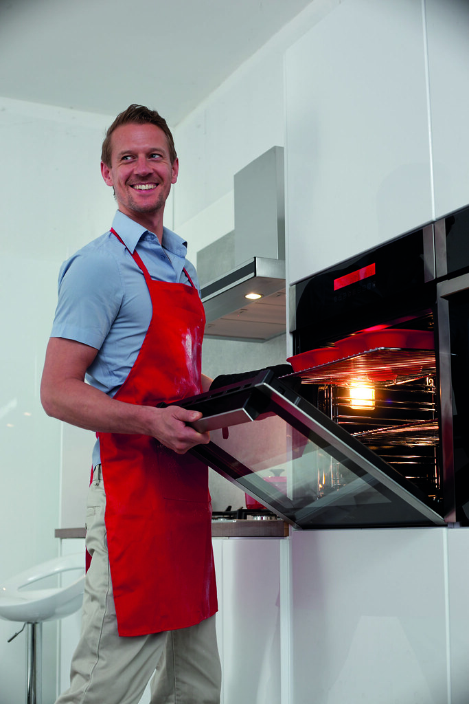 Man cooking dinner and using oven Man cooking dinner in ov… Flickr
