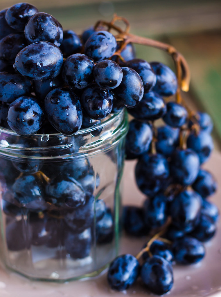 sweet twig of blue grapes in a glass, closeup blue grapes … Flickr
