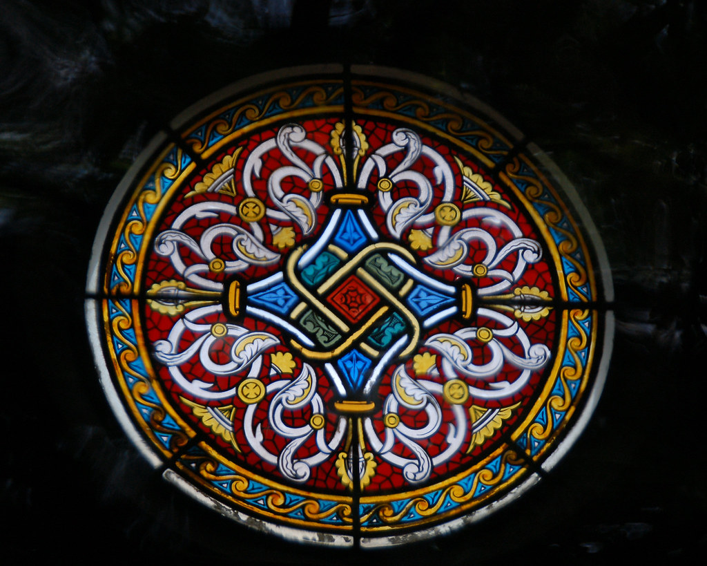 Stained glass window with quatrefoil design in middle Flickr