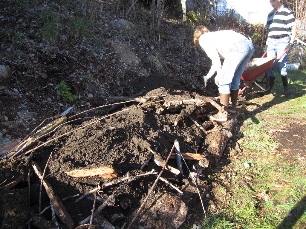 partially covered hugelkulture rotten wood is placed in a … Flickr