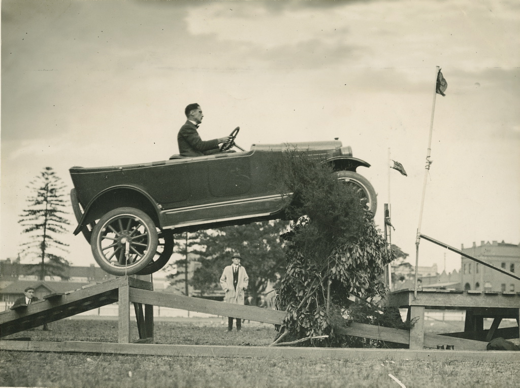 Overland car jumping a "fallen bridge" in a promotional stunt, 1920