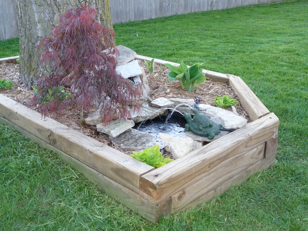 Fish Pond Our fish pond garden has gained some more orname… Flickr