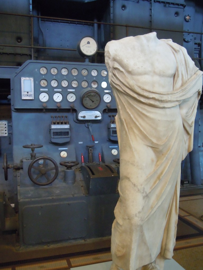 Statues juztaposed with industrial power equipment in the… Flickr