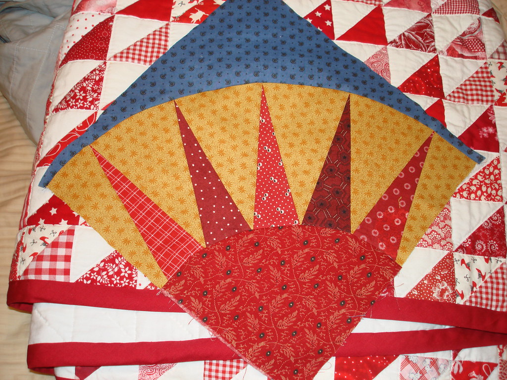 First Points of Pride block lying atop red triangles quilt… Flickr