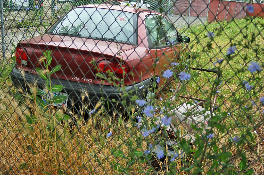 Lawnmower and car in lot SE 92nd south of Woodstock soon… Flickr