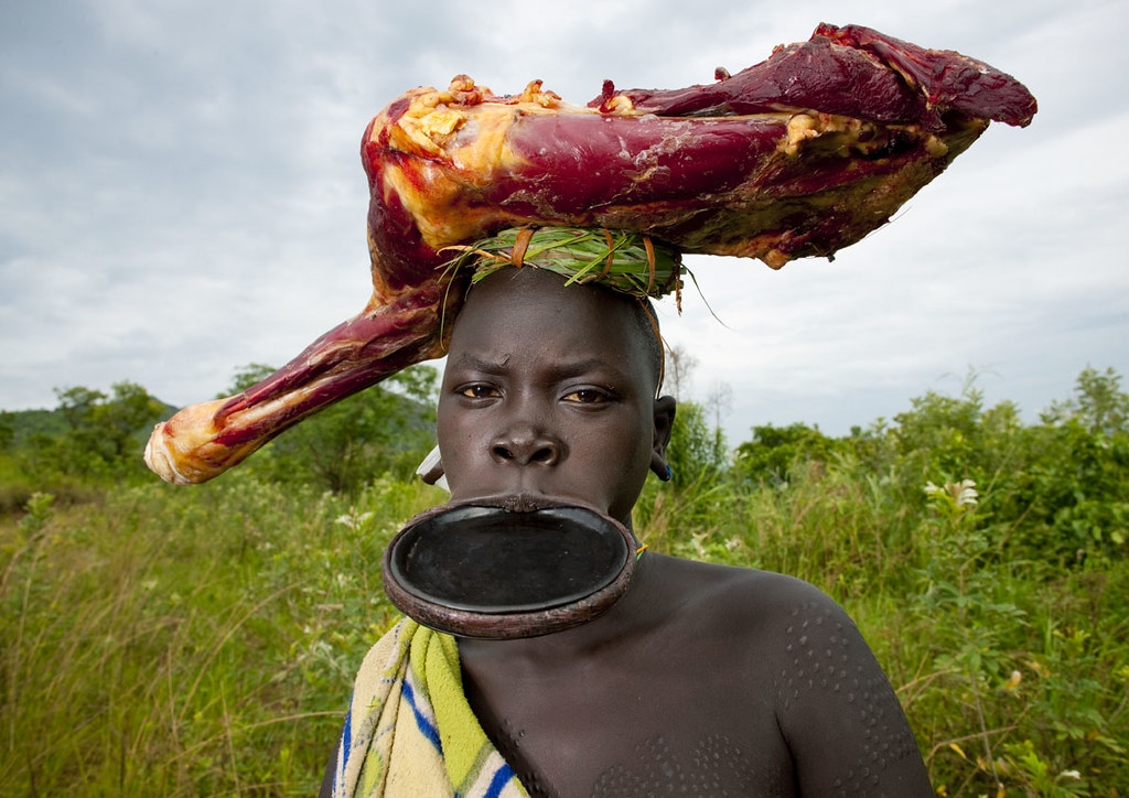 Surma girl bringing cow meat Ethiopia Like in all the po… Flickr
