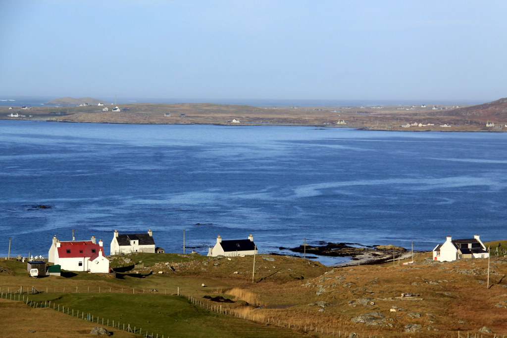 Eriskay houses ,in the distance South Uist and Orosay isla… Flickr