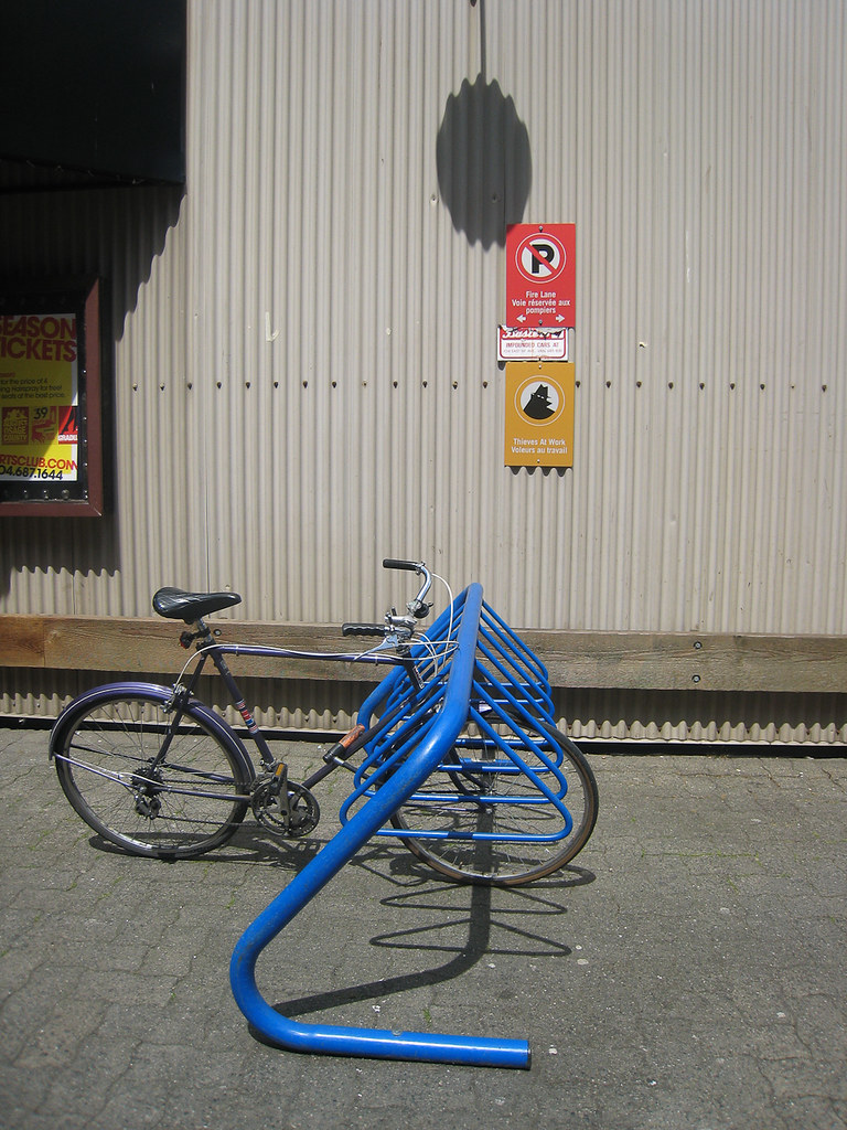Bikes, racked Bike parked on a blue rack, in front of a "f… Flickr
