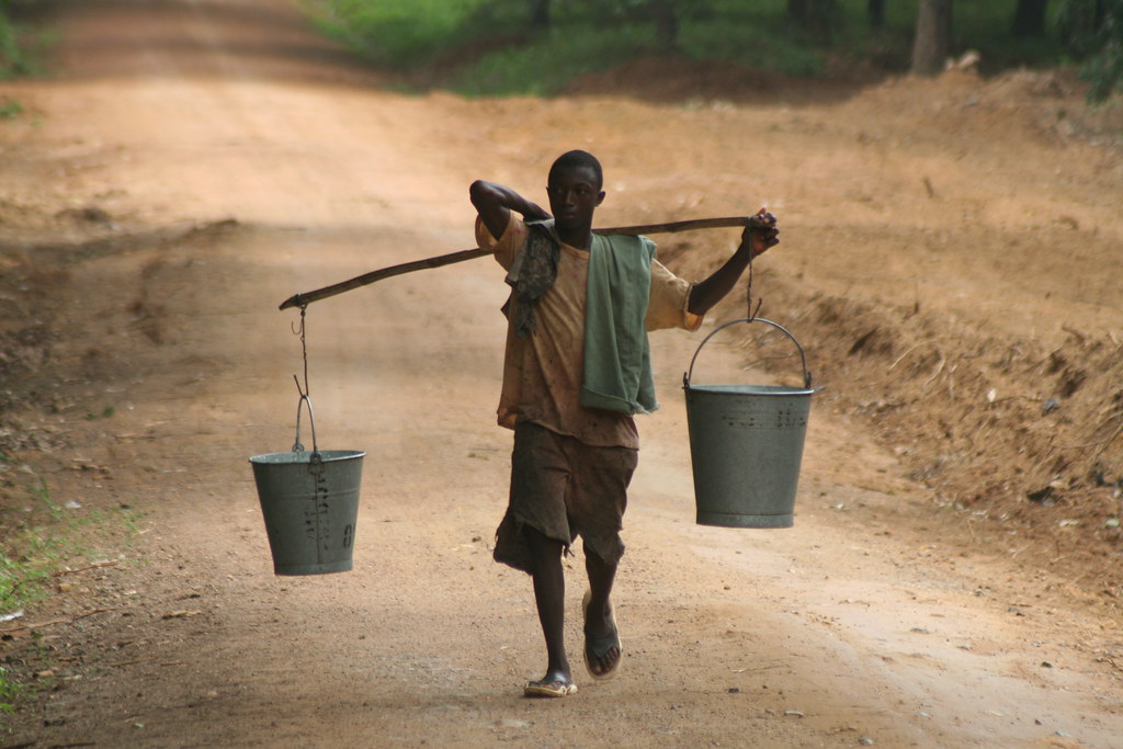 Man carrying buckets globalrights Flickr