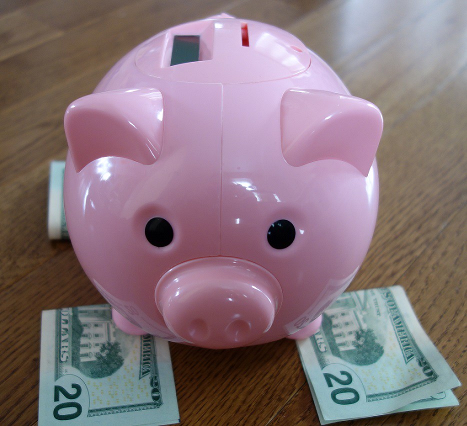 Piggy bank with dollar bills This is a photo of a pink pig… Flickr