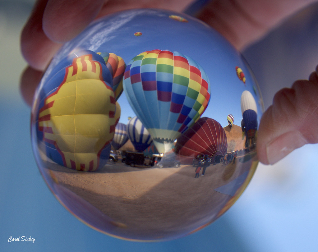 Hot air balloons captured in a spherical lens ball. Flickr