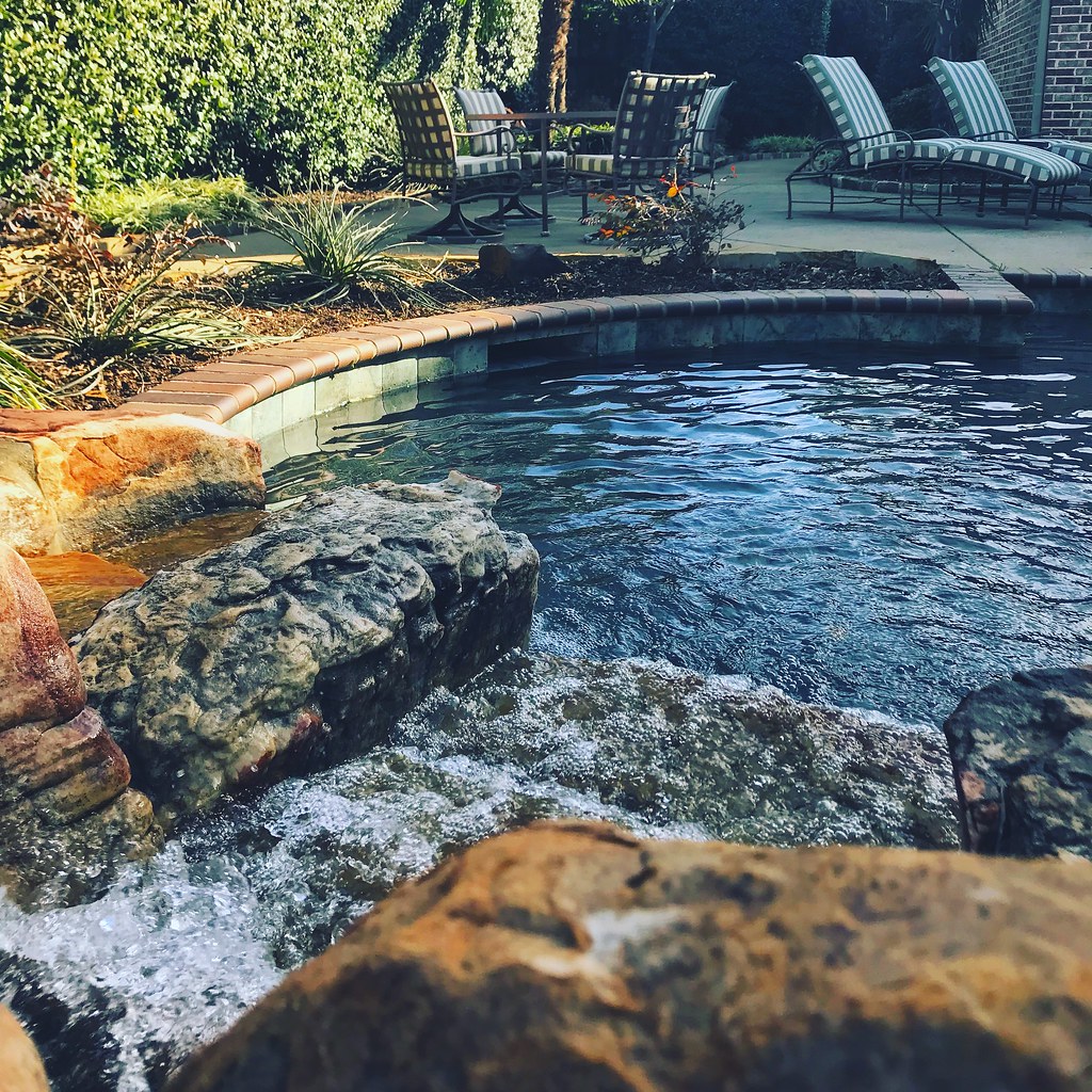 "custom rock features and flower beds in and around pools"… Flickr