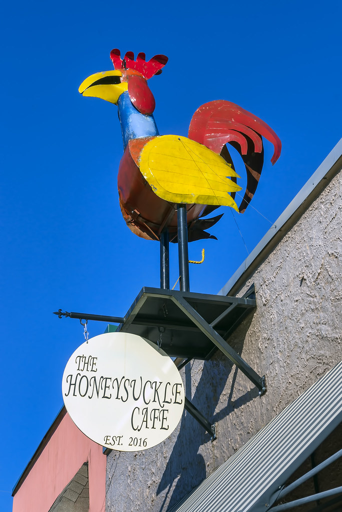 The Honeysuckle Cafe A sign hanging above the entrance to … Flickr