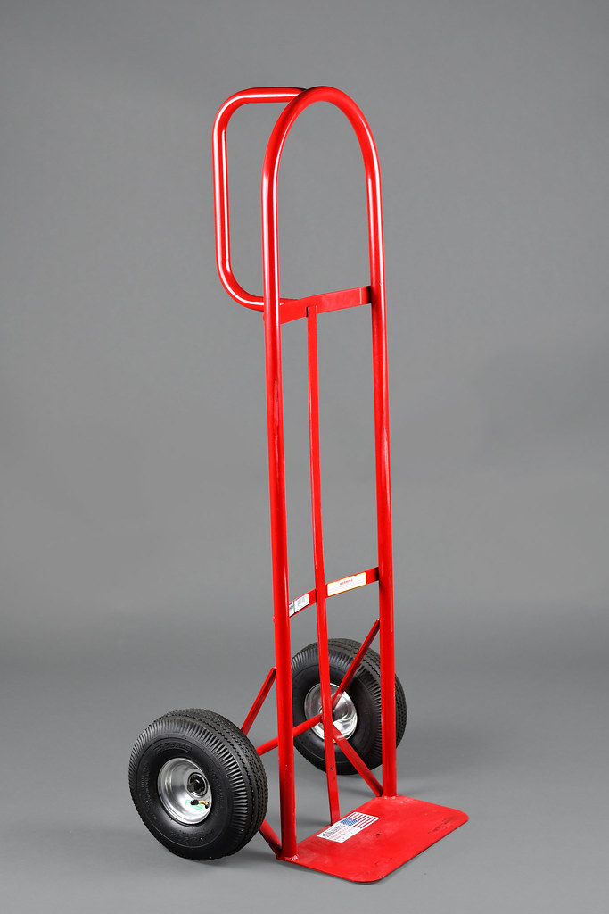 Red Hand Truck A red Dhandle hand truck with a grey backg