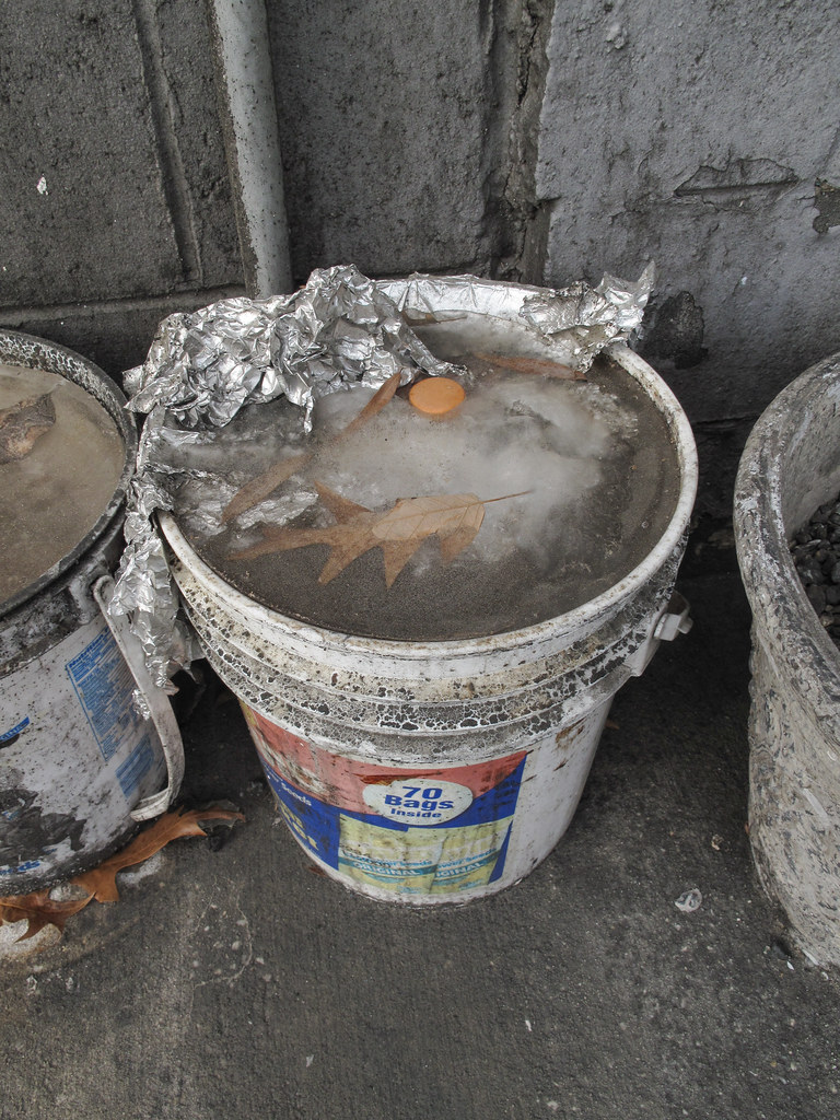 Rotten old filthy dirty old plastic bucket of ice & foil. Flickr