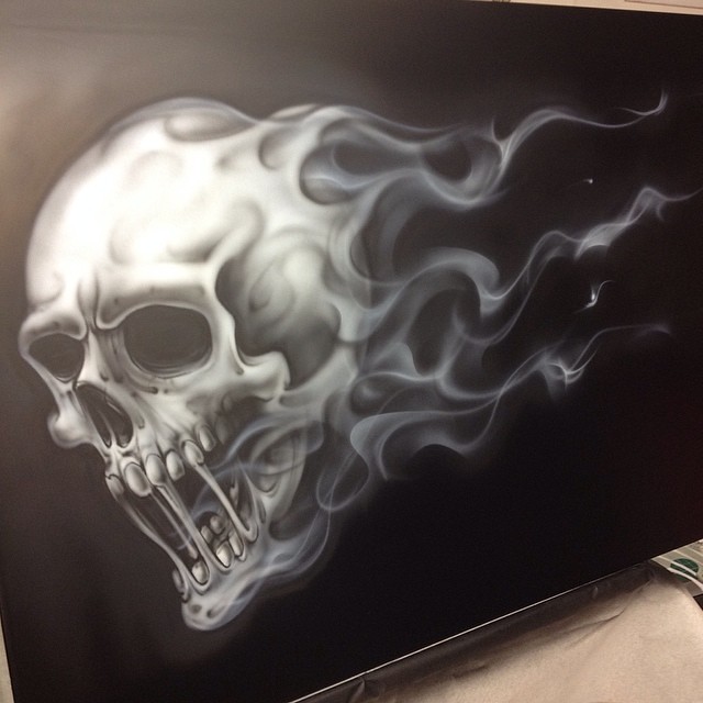 Skull with flames, Step 2 shading and detail with thinned black. 