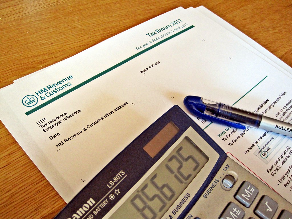 HMRC A HMRC tax return, calculator and a pen. Like much of… Flickr