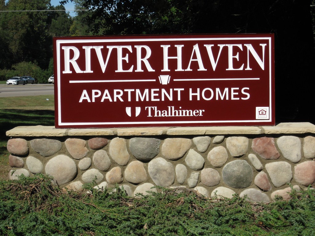 River Haven Apartments Stone sign with carved Extira faces… Flickr